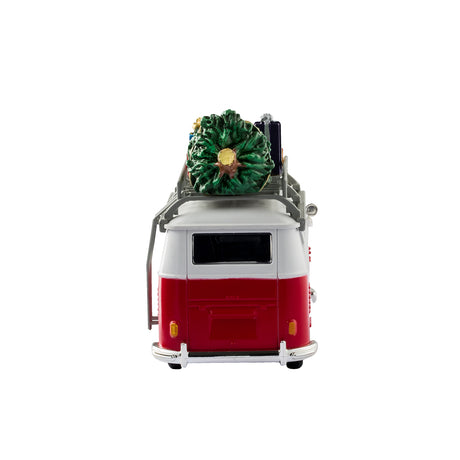 Plastic table accent for a Lemax display. Designed to look like a red and white Volkswagen bus. The sides read "Have a Holly Jolly Christmas" and features little holly leaves and berries. There's a decorated wreath on the front bumper. There's a ladder on the side that leads up to the roof of the van where there's a collection of presents and a Christmas tree.
