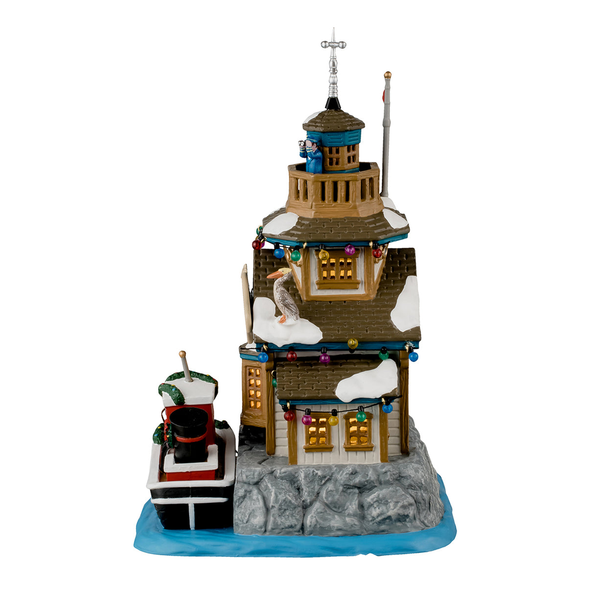 Porcelain lighted building for a Lemax display. Designed to look like a building next to a body of water. There's someone using binoculars on the balcony on the roof. There are multi-colored lights and a pelican sitting near the sign. The sign reads "Northstar Cape Harbor Master." There's a boat tied up at the dock. The boat has the word "PILOT" written on the side and has a decorated garland around it.