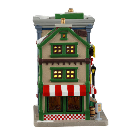 Porcelain lighted building for a Lemax display. Designed to look like two, colorful shops in the West Side Market. The shop on the left is Bob's Sausage Shoppe & Butcher. There's a wreath on the door and you can see the meat hanging inside. There's a sign on the ground that reads "SALE BOGO." The shop on the right is called Bennet the Fishmonger. You can see all the fish inside.
