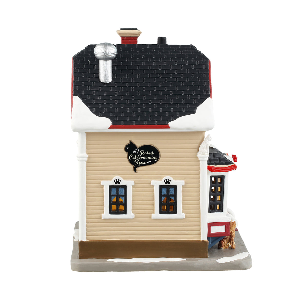 Porcelain lighted building for a Lemax display. Designed to look like a Victoria-era house that's been turned into a cat grooming office. There's snow on the roof and the sidewalk. There are different colored cats all over the place. Inside the window, you can see one of the groomers hard at work. There are red ribbon accents and two small potted trees.