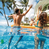 This is a lifestyle image showing people playing volleyball in some water.