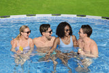 This image shows four people lounging in the pool and laughing.