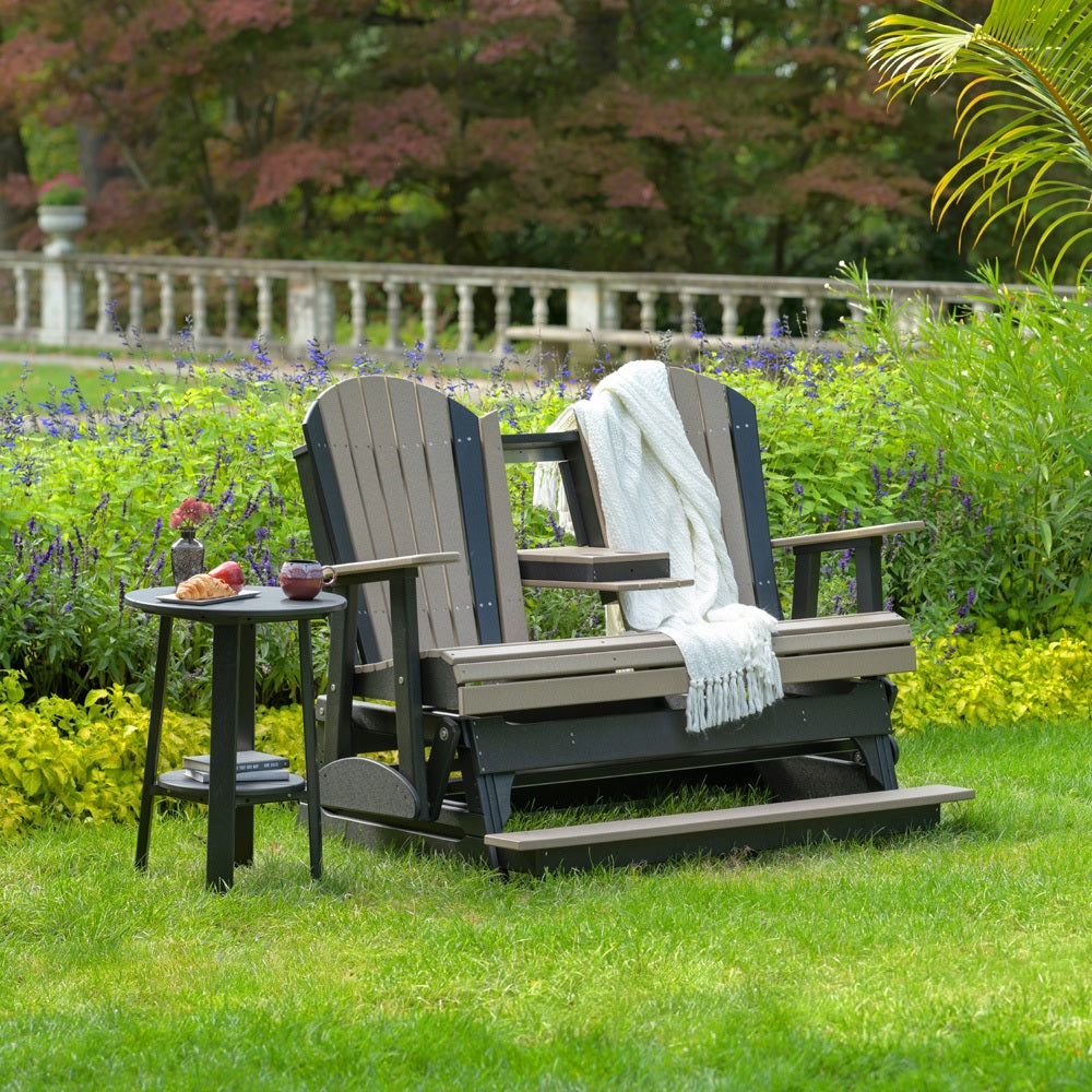 This is a lifestyle image of a Weatherwood and Black Adirondack balcony glider bench with the center console down.