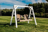 This is a lifestyle image showing the Antique Mahogany and Black colored porch swing.