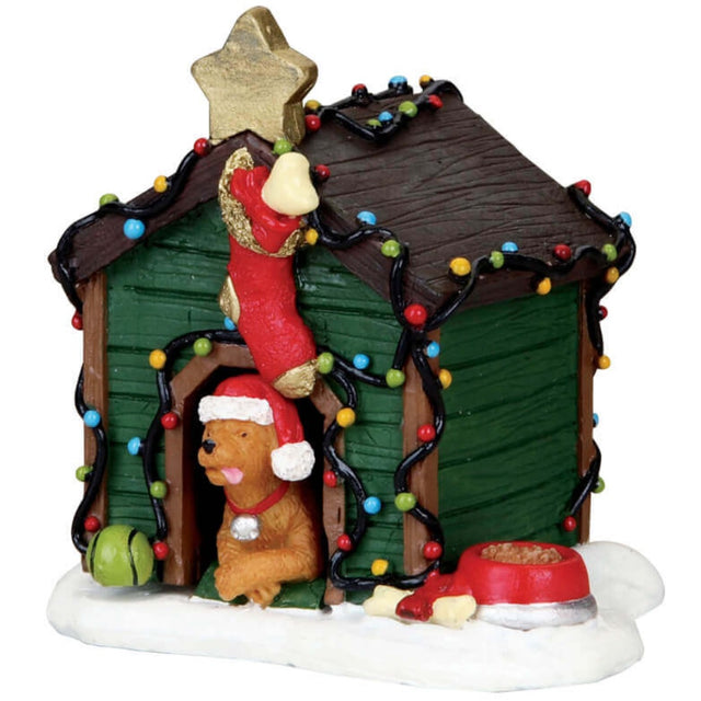 Polyresin  figurine for a Lemax Village tabletop display. Designed to look like a green and brown wooden dog house that's been decorated for Christmas. Features a gold star on the top, a red and gold stocking, multi-colored lights and a dog wearing a Santa hat
