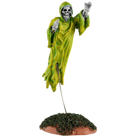 This image shows what this Lemax Spooky Town figurine looks like on a white background. It was designed to look like a skeleton wearing a yellowish-green robe flying over a small grassy patch of land.