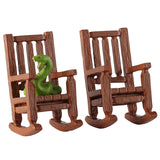 This image shows what these two Lemax Spooky Town accessories look like on a white background. They're designed to look like wooden rocking chairs. One of the chairs has a green snake with red eyes sitting on it.