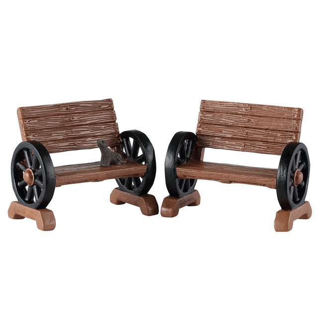 This image shows what these two Lemax Spooky Town accessories look like on a white background. They're designed to look like benches. The arm rests are made out of wheels.