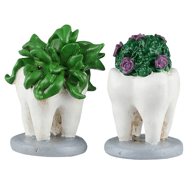 This image shows what these two Lemax Spooky Town accessories look like on a white background. They're designed to look like plants growing out of large teeth.