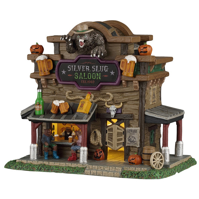 This image shows what this Lemax Spooky Town lighted building looks like on a white background. It was designed to look like a wooden saloon. There are jack-o-lantern accents and large decorative beer bottles and glasses. At the bar, there are two werewolves drinking and chatting with the bartender.