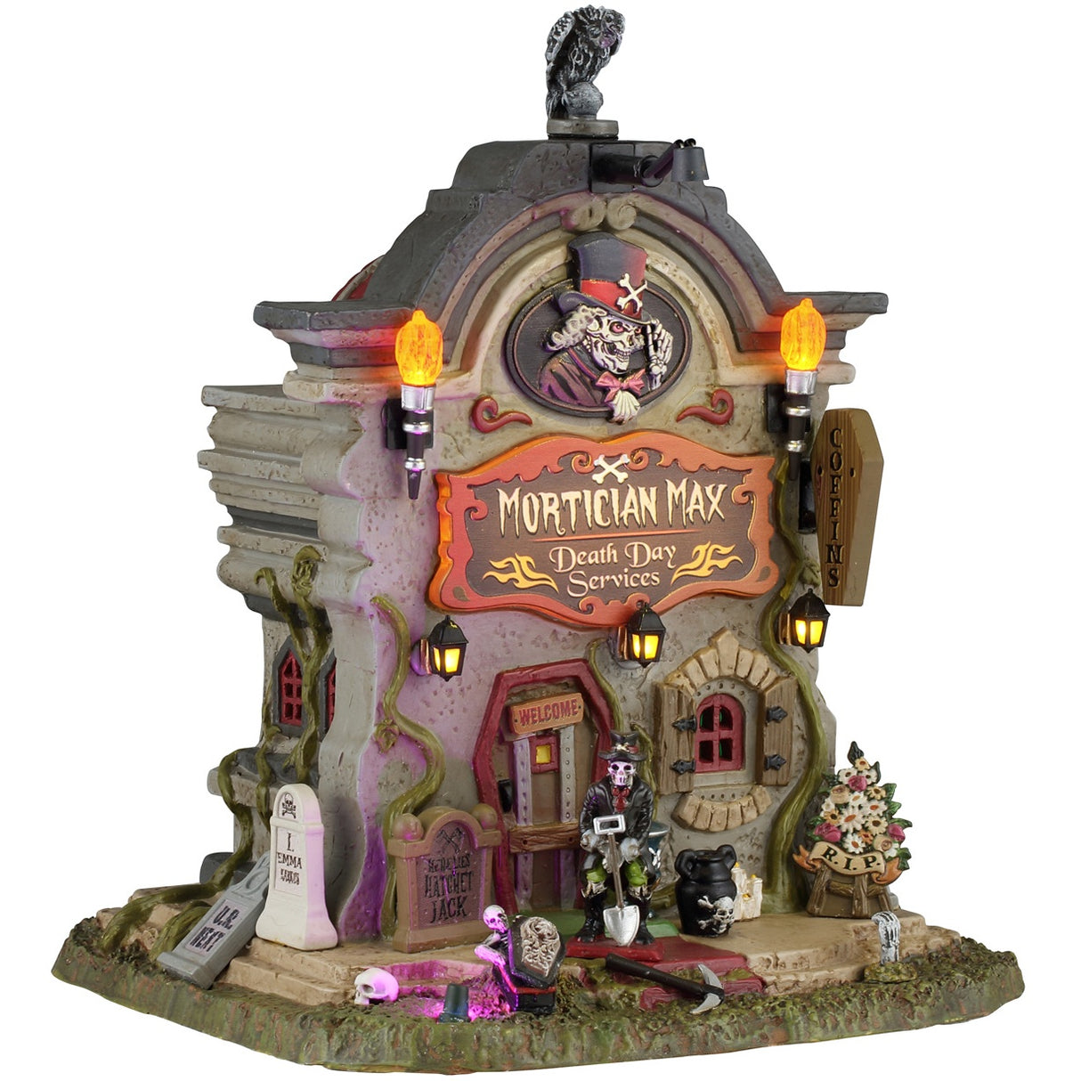 This image shows what this Lemax Spooky Town lighted building looks like on a white background. It was designed to look like a tall building shaped like a headstone. The sign reads "MORTICIAN MAX. DEATH DAY SERVICES" and above it, there's a Victorian-era looking skeleton man tilting his top hat. There's a skeleton with a skeleton standing near the front door.
