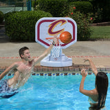 This is a lifestyle image showing two people playing basketball in the pool, aiming the ball for the Cleveland Cavaliers themed basketball hoop.