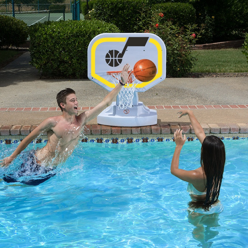 This is a lifestyle image showing two people playing basketball in the pool, aiming the ball for the Utah Jazz themed basketball hoop.