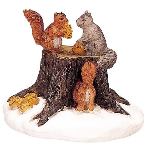 Polyresin figurine for a Lemax display. Designed to look like a tree stump with squirrels sitting on it. There's snow on the ground.