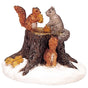 Polyresin figurine for a Lemax display. Designed to look like a tree stump with squirrels sitting on it. There's snow on the ground.
