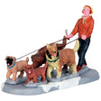 Village accent for a Lemax display. Designed to look like a young person walking a pack of dogs in the snow.