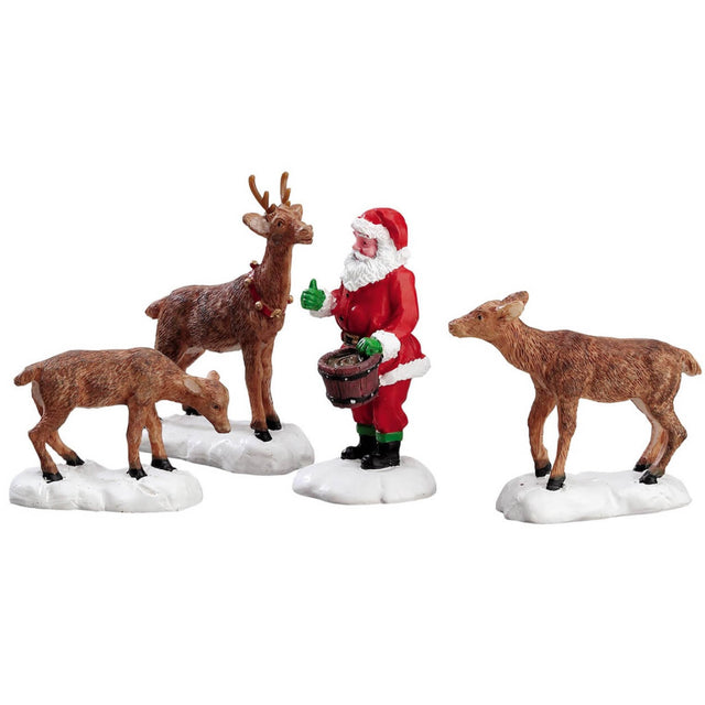 Polyresin figurines for a Lemax display. Designed to look like Santa Claus wearing his traditional garb. He's feeding three reindeer in the snow.