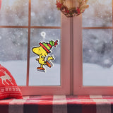 This is a lifestyle image showing the Woodstock decoration hanging in a window while it snows outside.
