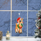 This is a lifestyle image showing the Rudolph decoration hanging in a window among other Christmas decorations.