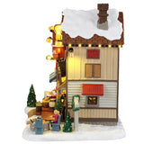 This image shows what the side of this building looks like. There's a woman roasting a marshmallow over a fire pit.