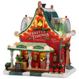 This image shows what this Lemax Santa's Wonderland lighted building looks like on a white background. It was designed to look like a red house turned into the Festive Tidings Nursery. On the porch, there's a table with elf made wreaths for sale. On the side of the house, there's an elf decorating wreaths. There are two dome windows on the roof where you can see some trees inside.