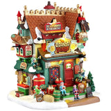 This image shows what this Lemax building looks like on a white background. It was designed to look like a uniquely decorated, tall restaurant. There's a sign on the roof that reads "The Best Eggnog in the Arctic!" There are elves sitting around, from the roof to the front stairs. There's snow on the roof and the sidewalk. There are lots of little signs everywhere.