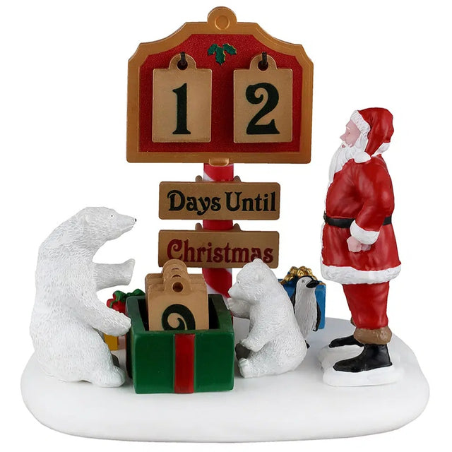 This image shows what this Lemax Santa's Wonderland table accent looks like on a white background. It was designed to be a Christmas countdown tabletop piece. It looks like Santa Claus, two polar bears and a penguin are changing the countdown on the sign.