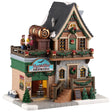 This image shows what this Lemax building looks like on a white background. It was designed to look like a tall cottage that has been turned into a brewery. In the garage area, there are kegs of beer. The front porch is decorated with garlands, trees and wreaths. On the second floor balcony, there are people standing around having a taste test next to a large, golden keg.