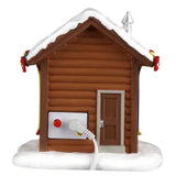 This image shows what the back of this small log cabin looks like. There's a wooden door and you can see the On/Off switch.
