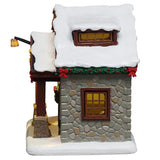 This image shows what the side of the house looks like. You can see the green garland with red bows along the roofline and a window.