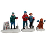 This image shows what these three Lemax Vail Village figurines look like on a white background. They were designed to create a scene showing two kids and one dog getting ready to shovel snow.
