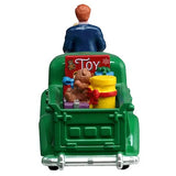 This image shows what these figures look like from the back. The truck is green and in the bed of the truck, there are teddy bears and presents and toys.