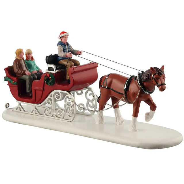 This image shows what this Lemax General Collectibles table accent looks like on a white background. It was designed to look like a horse leading a red sleigh carrying three people through the snow.