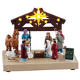 This image shows what this Lemax General Collectibles table accent looks like on a white background. It was designed to look like eight people putting on the Nativity play. They're on a wooden stage made to look like a barn decorated with lots of lit up stars.