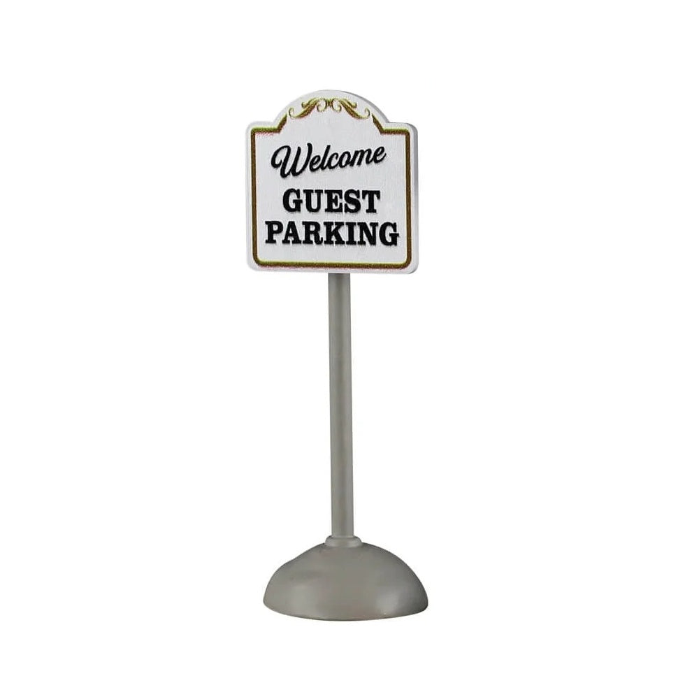 This image shows what one of the signs looks like on a white background. This one reads "Welcome Guest Parking." The pole is silver and the sign is white with black text and  gold trim.