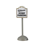 This image shows what one of the signs looks like on a white background. This one reads "Welcome Guest Parking." The pole is silver and the sign is white with black text and  gold trim.
