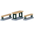 This image shows what these Lemax Village accessories look like on a white background. It was designed to look like a table with two benches. The top of the table and the benches are a light brown color and the bottoms are a dark green.