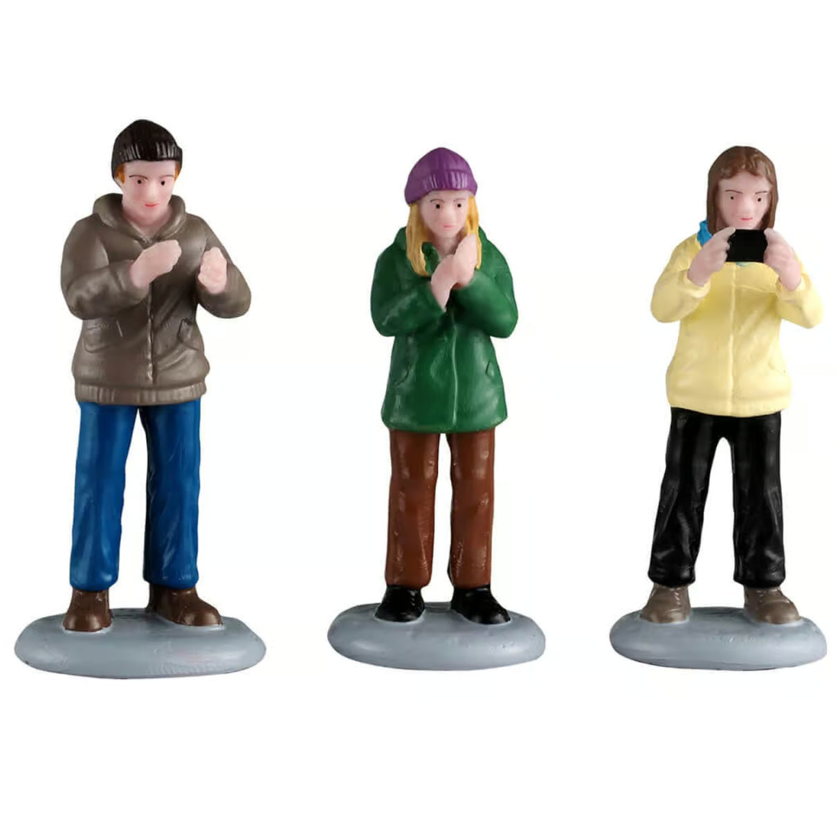This image shows what these three Lemax General Collectible figurines look like on a white background. They were designed to look like people watching a performance, clapping and taking pictures.