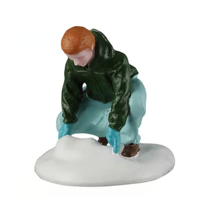 This figurine was designed to look like a boy bending down to gather snow to create a snowball. He's wearing a forest green jacket, blue jeans and brown shoes.