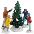 This image shows what these five Lemax Caddington Village figurines look like on a white background. This was designed to create a scene that looks like a family picking out a tree to chop down for Christmas. The dad is wearing a brown jacket. The mom is wearing a blue jacket. The daughter is wearing a yellow jacket. The son is wearing an orange jacket.