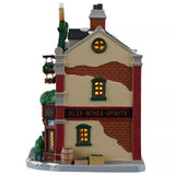 This image shows what the other side of this building looks like. There are three windows and a sign that reads "Ales, Wines, Spirits." On the sidewalk, there are boxes of bottles.