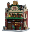 This image shows what this Lemax building looks like on a white background. It was designed to look like a tall cottage turned into a pub. There's a large, fake gold mug of beer on the roof. There's a window near the front door and you can see people drinking inside. There are kegs of beer and potted trees on the sidewalk, along with snow.