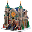 This image shows what this Lemax building looks like on a white background. It was designed to look like a very large, intricate cathedral. There are gold steeples, gold crosses and stained glass windows. There's a nativity scene near the front door.