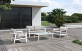 This is a lifestyle image showing the patio furniture set on a wooden deck on the side of a house.