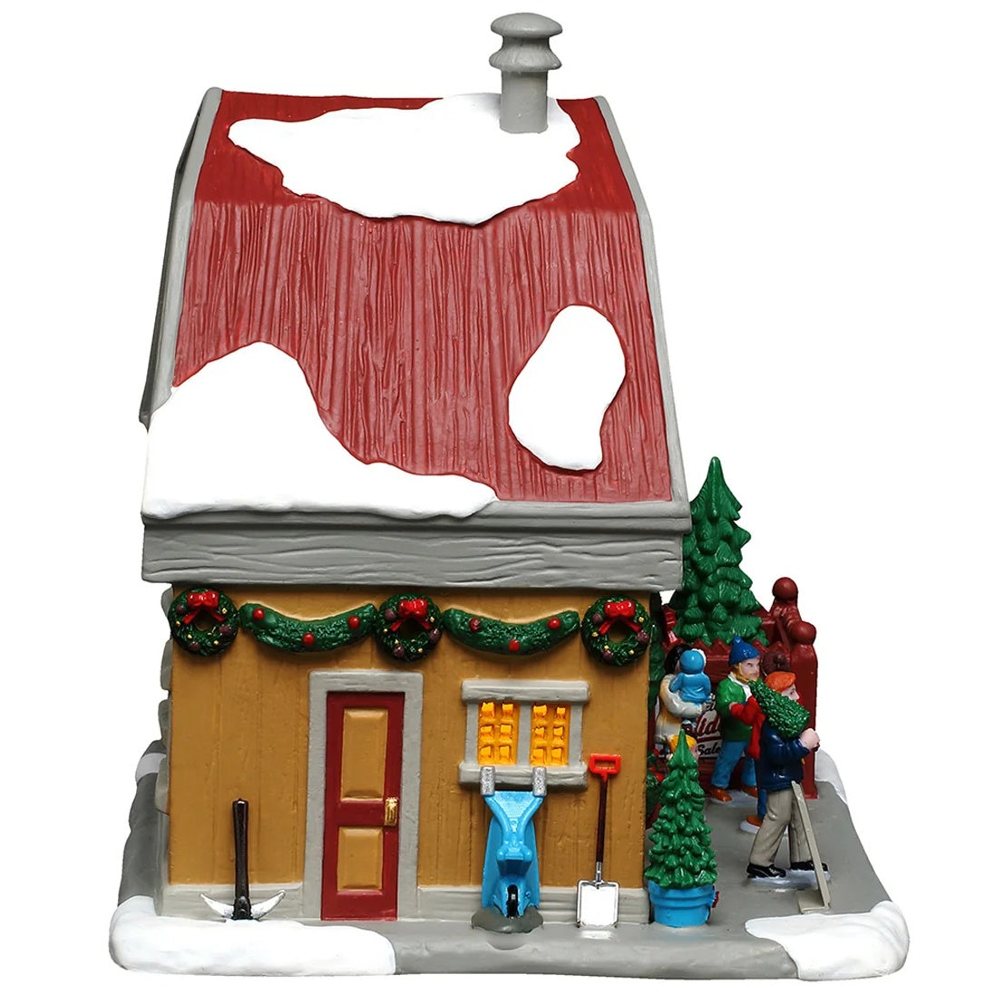 This image shows what the side of this building looks like. There's a snowmobile, an axe and a shovel leaning up against the wall.