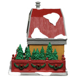 This image shows what the other side of this building looks like. The fenced in area has lots of trees. The fence is decorated with wreaths and garlands.