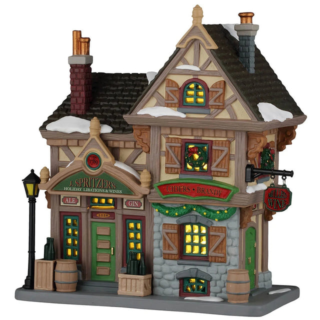 This image shows what this Lemax building looks like on a white background. It was designed to look like an old time-y cottage turned into a liquor store. There's some snow on the roof and on the sidewalk. There's green garland and decorated wreaths all over. There are kegs and glass bottles sitting on the sidewalk in front of the building.