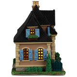 This image shows what the side of this building looks like. There are bushes, trees and planters outside of the window.