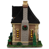 This image shows what the other side of this building looks like. There's a tall, stone chimney with a wreath on it.