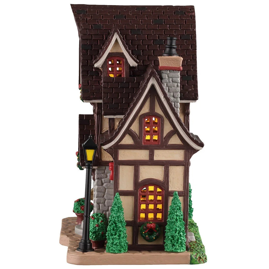 This image shows what the other side of this building looks like. There are windows, trees and wreaths.